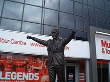 Statue of a man with his arms held aloft